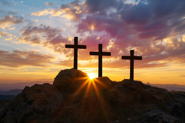 Three crosses silhouette, standing on a rock, sun shining on the crosses - obrazy, fototapety, plakaty