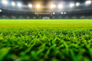 Fototapeten Vibrant Green Grass Field With Stadium And Flood Lights In Blurred Background © Anastasiia