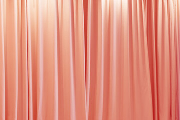 Peach fuzz color theater curtain that dropped down as a straight line. Background for inserting...