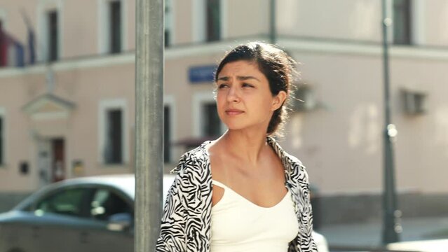 Young beautiful smiling hipster woman in trendy summer zebra print costume clothes. Carefree model posing in the street at sunset. Positive brunette female. Cheerful and happy. In sunglasses