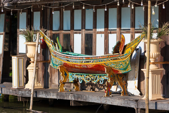 Pattaya, Thailand - 19 December, 2023: View on multicolored and decorated Thai traditional wooden boat on floating market, Thailand. Kolek or Koleh traditional fishing boat. Selective focus