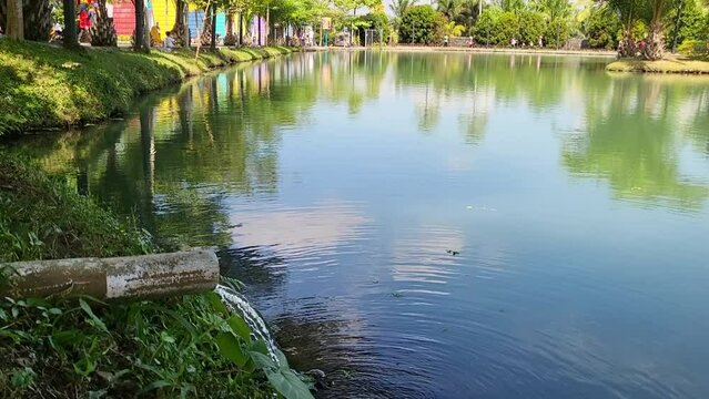 View of a beautiful artificial lake. The lake is called the lake of love. There are duck water bikes to get around the lake.