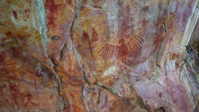 Prehistoric primitive cave art. Red painting of lizard on wall in Brazil