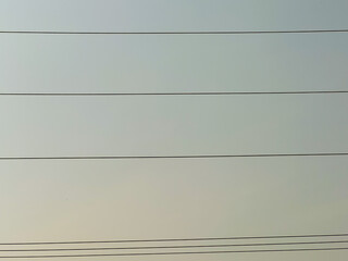 The sky and the electrical wires arranged in lines