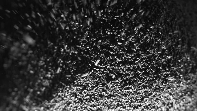 Biochar crumbles in a heap, coal particles falling, Pyrolysis, Decarbonization.