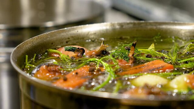 Close-up of a pot of boiling broth. Cooking soup in a restaurant