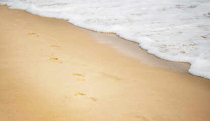 Beach, feet prints in the sand. Wave, travel, holiday, beauty, relax concept wallpaper.