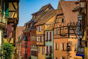 Traditional colorful half timbered houses in a popular village on the Alsatian Wine Route in...