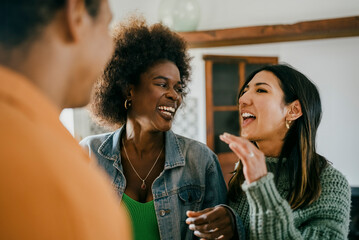 Happy woman talking with friends at party in kitchen