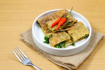 Martabak Telor or Martabak Telur. Savory pan-fried pastry stuffed with egg, meat and spices. Martabak Telur is one of Indonesia street food