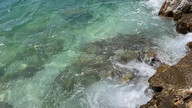 Rocky beach and crystal turquoise water of Ionian Sea in Albania.