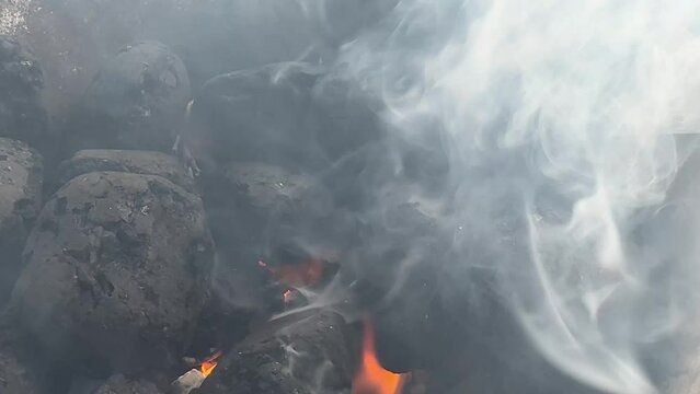 Smoldering Charcoal with Fire Flames in Outdoor Grill.