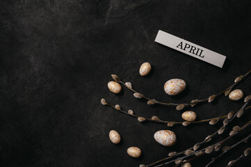 easter background with willow,eggs and april inscription. copy space banner