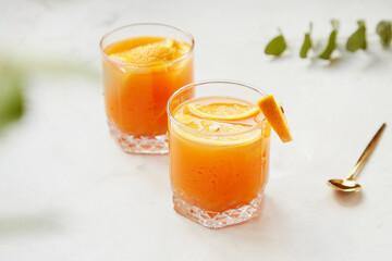 Fresh orange cocktails with fresh citrus fruits. Lemonade, refreshing drinks, low alcohol mocktails, hard seltzer, summer party concept. Shadow and sunlight.