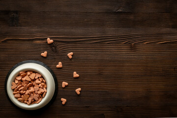 Food and treats for pets - biscuits in a shape of heart in a bowl