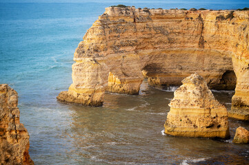 Fototapeta na wymiar Nature's Sculpture Algarve's Unique Coastal Rock Landscape. Travel destination, hiking. Blue sea.