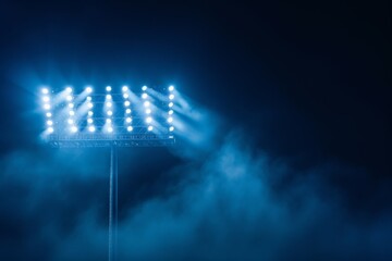 Lights in the stadium against a dark night sky - obrazy, fototapety, plakaty