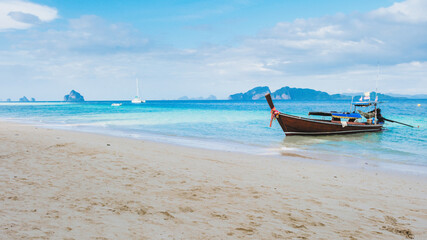Fototapeta na wymiar Longtail boat on the tropical beach of Koh Kradan Trang Thailand
