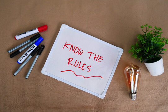 KNOW THE RULES text, handwritten as a note on a white board.