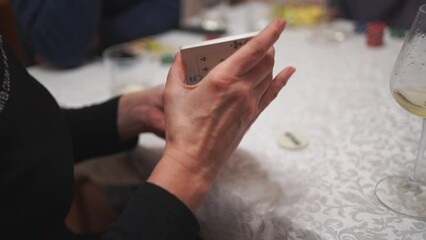 Close-Up of Woman's Hand Holding Playing Cards at Social Even