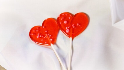 Valentine's Day concept. Two red paired heart-shaped lollipops.