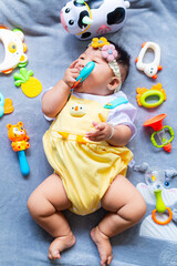 Obraz premium Baby in cute outfit with toys,Little girl 3-6 months old in cute outfits
