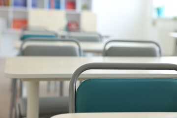 Empty school classroom with desks and chairs