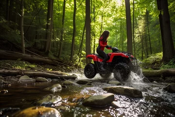 Foto op Canvas female rider crossing a forest stream on an atv, water rippling © primopiano