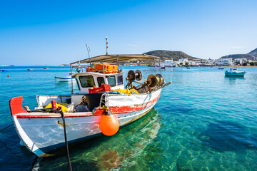 Colorful fishing boat on azure sea in Pollonia port, Milos island, Cyclades, Greece