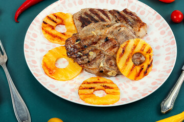 Grilled meat steak with pineapple.