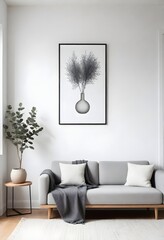 A minimalist living room with a light gray sofa, a gray throw blanket, a small wooden side table with a vase and branches, a round metal magazine holder, a framed wall art of a line drawing