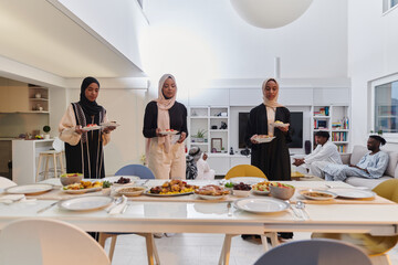 Group of young Arab women come together to lovingly prepare an iftar table during the sacred Muslim month of Ramadan, embodying the essence of communal unity, cultural tradition, and joyous