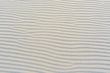 The beach with black sand. Background, texture, wavy pattern of the sand of the Adriatic Sea on Velika Plaza beach in Ulcinj, Montenegro.