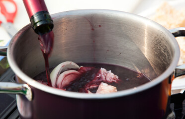 pouring wine into the pot