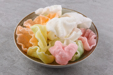 multi-colored rice chips on a stone background, studio food photography 1