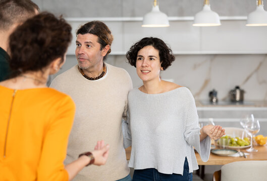 Married Couple Welcoming Guests For Diner Party At Home