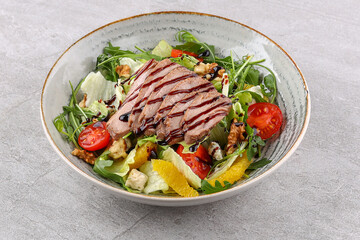 salad with boiled pork, tomatoes and cucumbers on a stone background, studio food photo 1