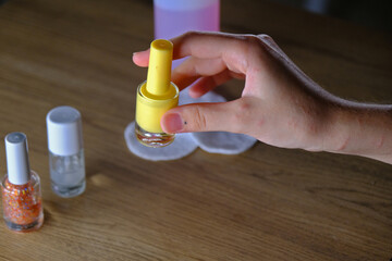 woman holding colorful nail polishes