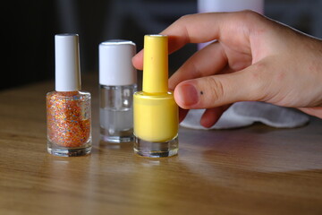 woman holding colorful nail polishes