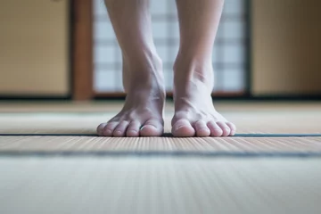 Fotobehang closeup of feet stepping onto a tatami mat, ready for training © primopiano
