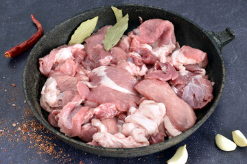 Pork meat cut into pieces ready for cooking.