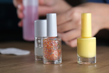 woman holding colorful nail polishes