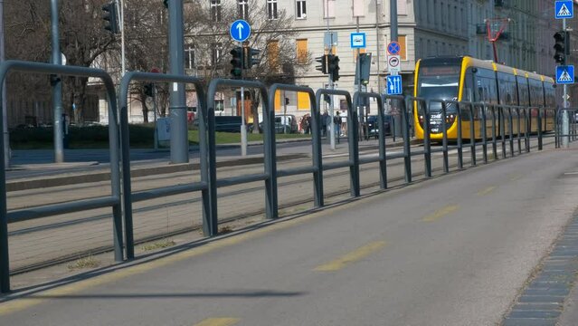 Cycling path next to the public road. A view of empty cycling path against public street in the day light.