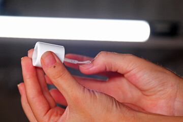 woman applying nail polish to her nails