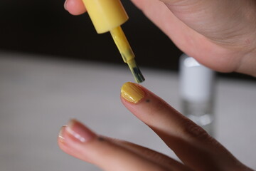 woman applying nail polish to her nails