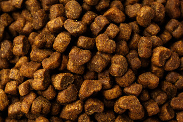 Dry pet food granules for background top view