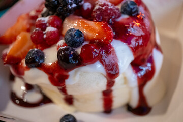 Japanese pancake with lots of fruit and syrup sauce in a restaurant in close-up