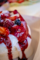 Japanese pancake with lots of fruit and syrup sauce in a restaurant in close-up	