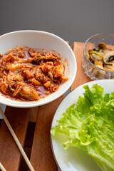 raising with various crops at the restaurant table, wrapping mushrooms and kimchee in cabbage