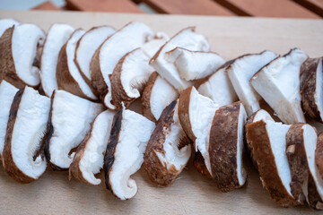 Chopped Shiitake mushrooms on board on wooden restaurant table
